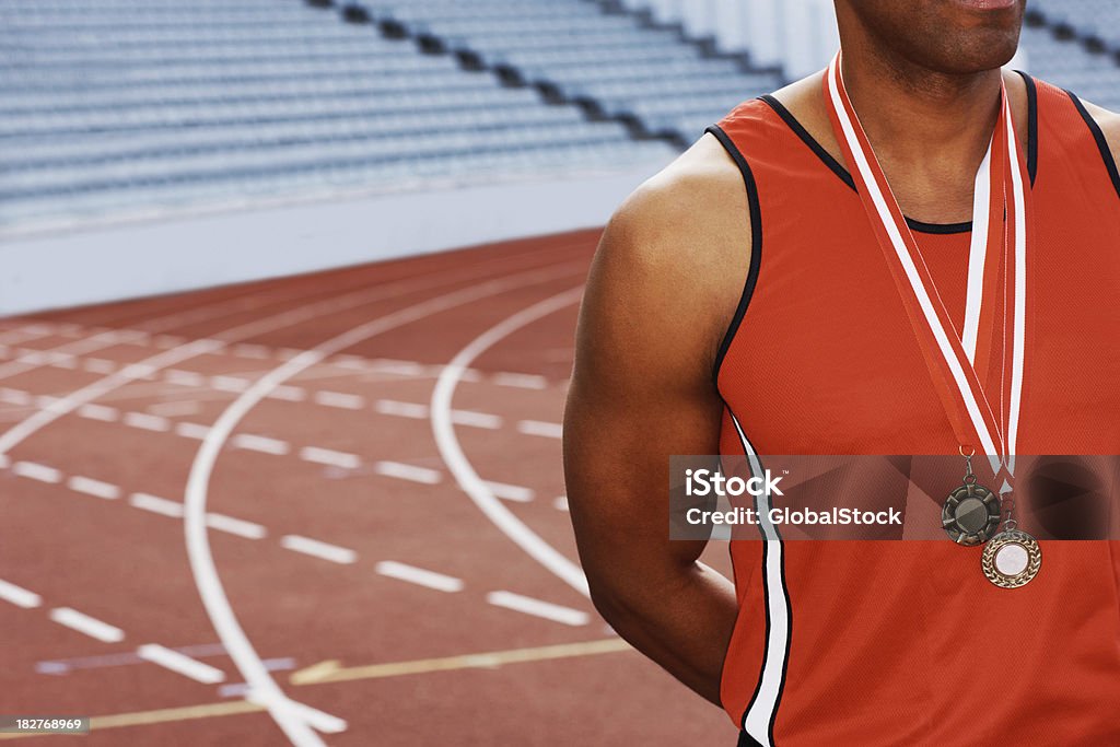 Sportowiec człowiek z dwóch medali wokół jego szyi - Zbiór zdjęć royalty-free (Bieżnia)