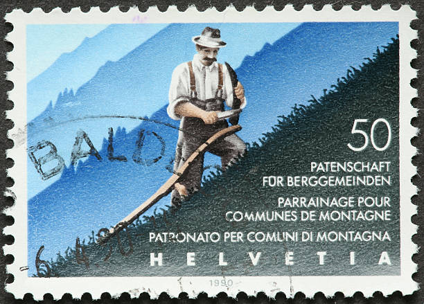 istock traditional farmer cutting grass on a Swiss mountainside 182769193