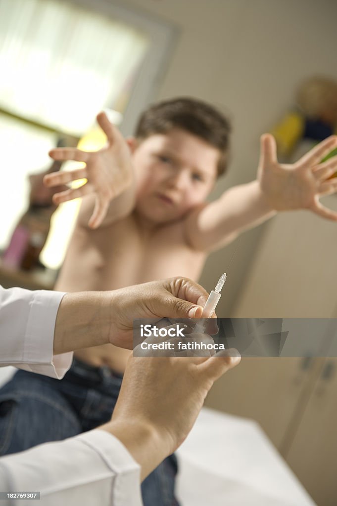 İnjecting Little boy is afraid of syringes.Focus in hand. Boys Stock Photo