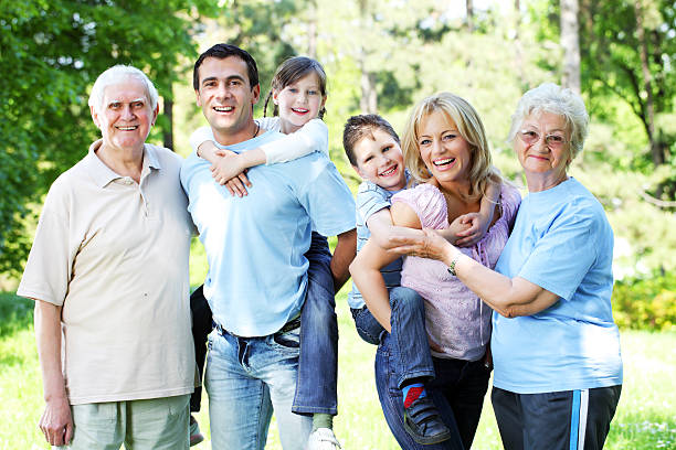 istock Extended happy family standing in the park. 182770071