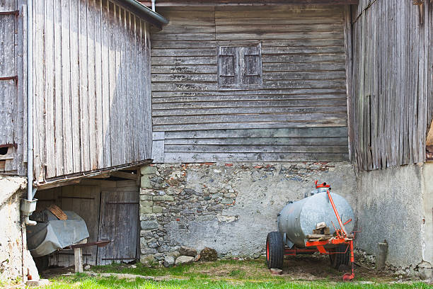 istock Manure Spreader Parked next to a weathered barn, Vaud Switzerlan 182770474
