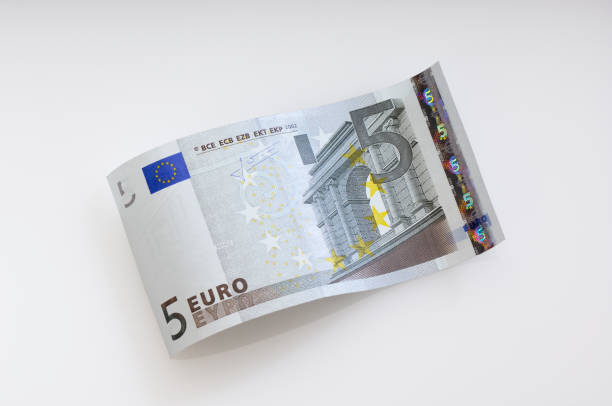 Five Euro dollar waves on the plain cream background Bent five Euro bill. (XXL-File) five euro banknote photos stock pictures, royalty-free photos & images