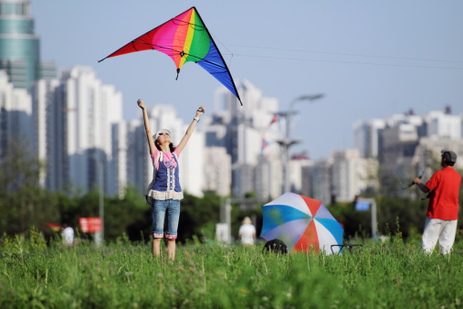 Asian girl taking off a colorful kite