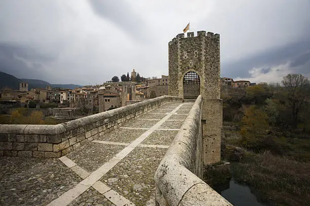"Medieval tower and bridge in a small Catalan Village. View of the town main entrance with it's famous bridge and tower. Shot in the town of Besalu, Griona, Spain. Format: Horizontal. Concept: Landmarks."
