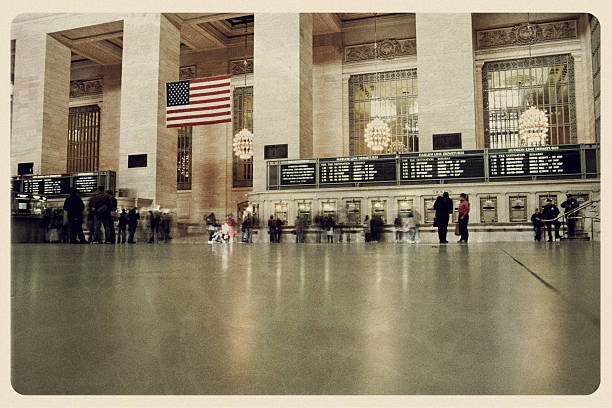 New York, USA - May 31, 2018: Panoramic view of people walking inside Grand Central Terminal, a world-famous landmark and transportation hub in Midtown Manhattan, New York.
