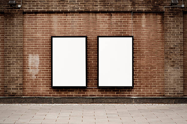 Street posters Two blank poster ads on weathered urban brick wall.Alternate files; two objects stock pictures, royalty-free photos & images