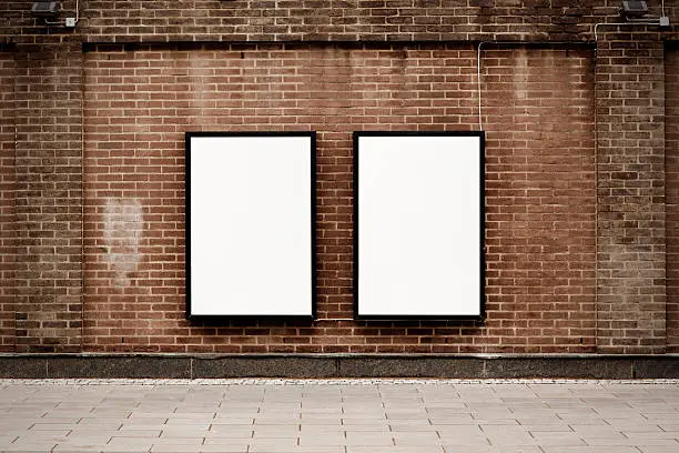 Two blank poster ads on weathered urban brick wall.Alternate files;