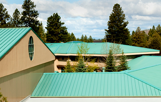 High angle of steel green roofing material on a multi-angled commercial building roof.http://www.garyalvis.com/images/buildingProjects.jpg
