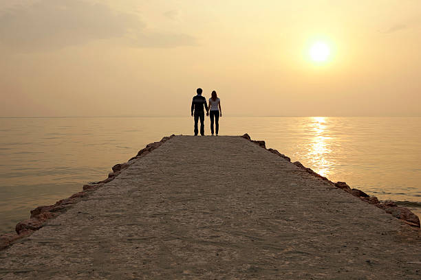 istock Happy couple on jetty looking the sunset 182771665
