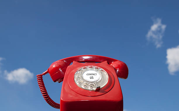 свяжитесь с нами - obsolete landline phone old 1970s style стоковые фото и изображения