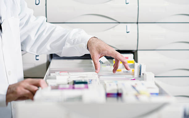 istock Pharmacist looking for medicine from drawer 182771848