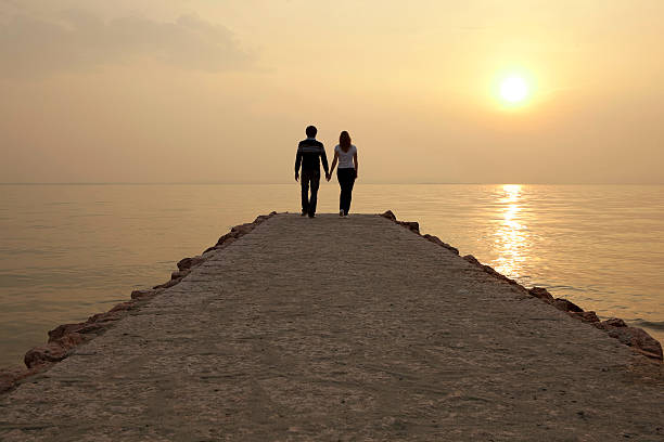 istock Happy couple walking on jetty 182771872