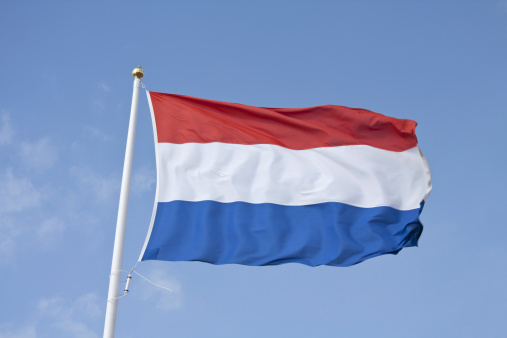 Dutch flag with golden nob on the flagpole