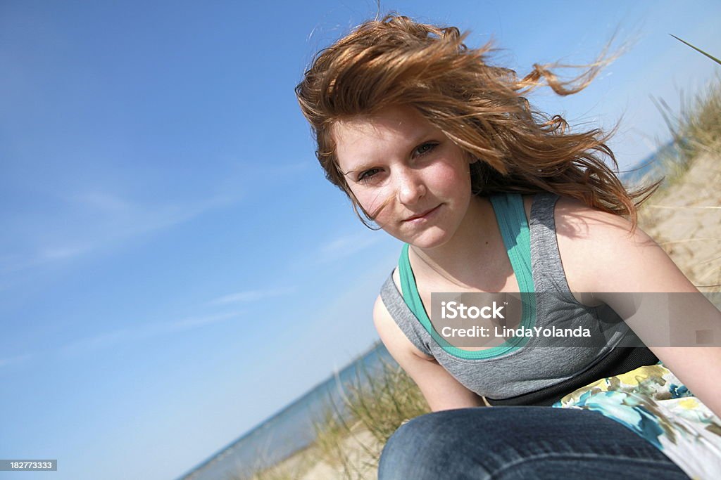 Beautiful Teen Girl A portrait of a beautiful 14 year old girl at the beach. Some copy space in blue sky. 14-15 Years Stock Photo