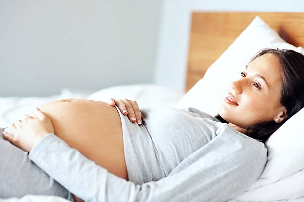 istock Contemplative pregnant lady relaxing on bed 182773617