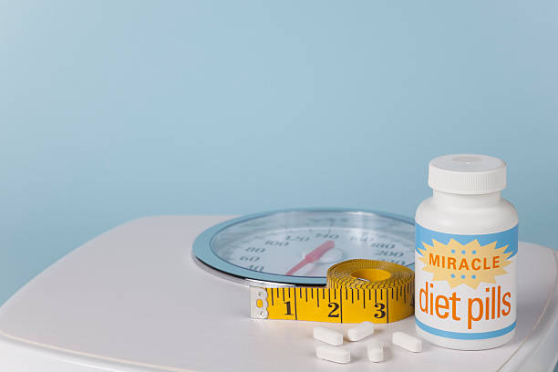 Miracle Diet Pills, Scale and Measuring Tape stock photo