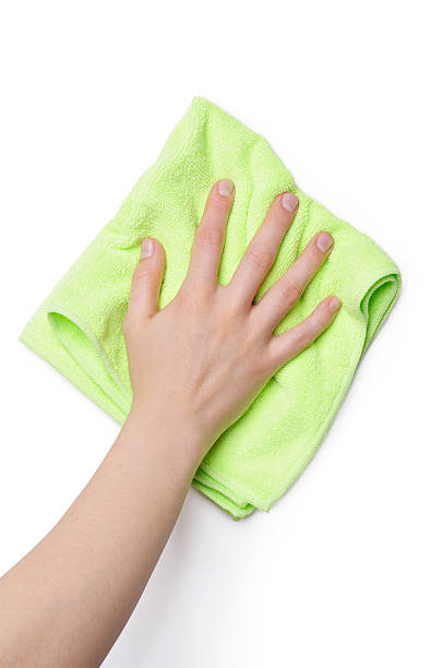 Cleaning with green cloth Hand isolated on a white background cleaning with a green cloth. rag stock pictures, royalty-free photos & images