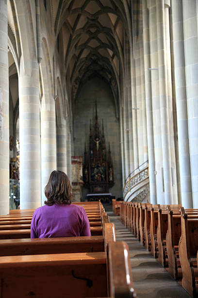 istock Woman praying in a church 182774997