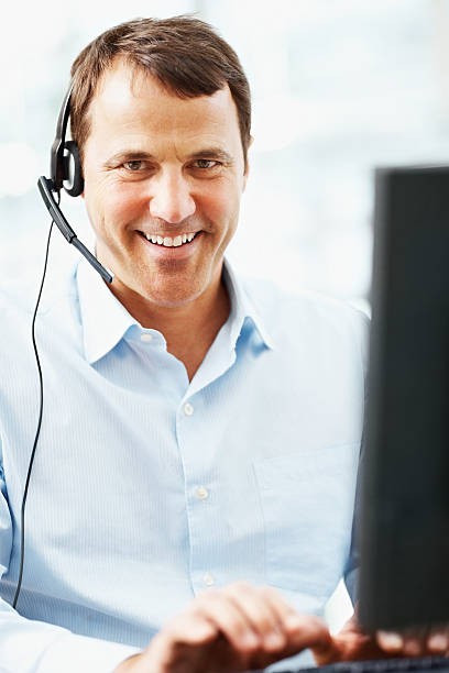 istock Portrait of a handsome call center employee working on computer 182775836