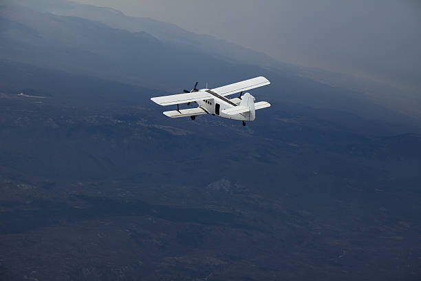 istock Old Biplane flying in the Sky 182776060