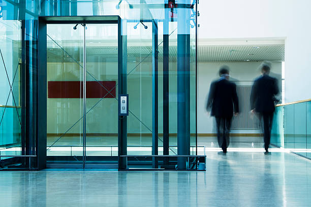 istock Two Businessmen Walking in Office Corridor, Blurred Motion 182776889