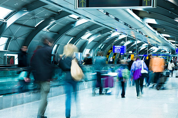 istock Blurred View of Travellers Walking Down Airport Hallway 182777078
