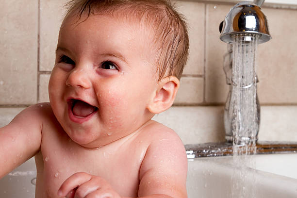 istock Cute Baby Boy Bathing in Kitchen Sink 182777442