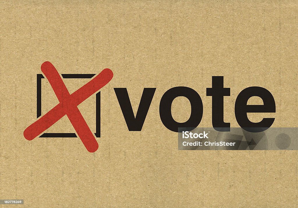 Vote in the election Vote and cross stamped onto the side of recycled cardboard Cross Shape Stock Photo