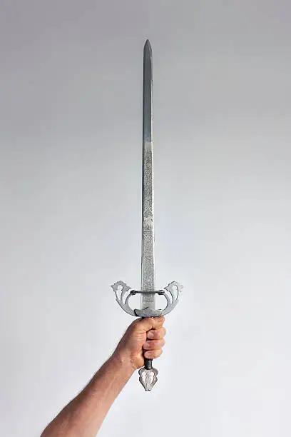 An arm holding up a sword