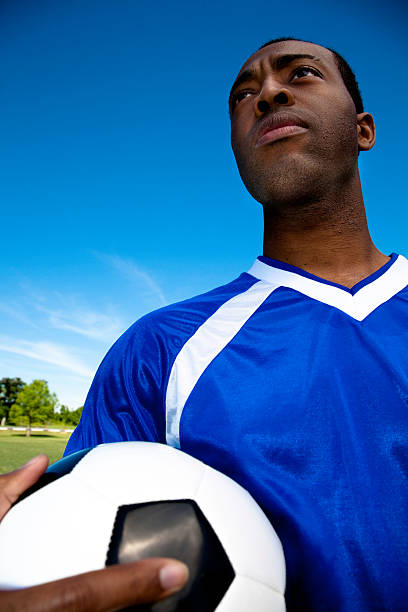 istock Young Athlete Holding Soccer Ball with Sky Copy Space 182778724