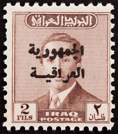 Detailed image of an Iraqi stamp circa 1950. Stamp franked over face in arabic.