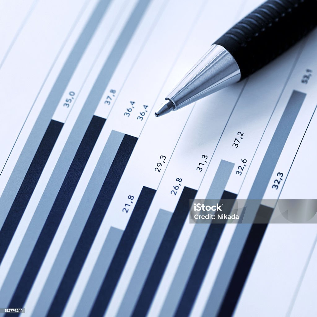 Financial Report "Pen showing diagram on financial report/ magazine shallow depth of field, blue toned" Analyzing Stock Photo