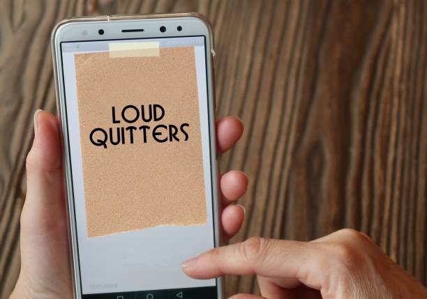 Smartphone mobile with stick note written Loud Quitters - Unhappy workers employees who unlike quiet quitters, vocalizing their negative sentiments aboutorganization before leaving