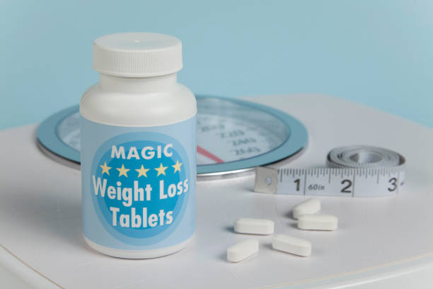 Weight Loss Tablets, Scale and Tape Measure stock photo