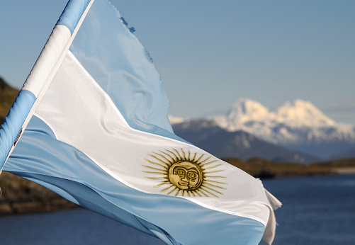 Argentinian flag with Patagonia in background. 