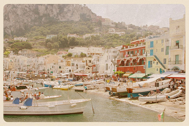 Port of Capri, Italy - VIntage Postcard Retro-styled postcard of the Capri waterfront - a popular tourist destination on the Amalfi Coast. All logos and signage have been removed. postcard from italy series stock pictures, royalty-free photos & images