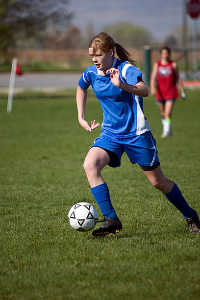 istock Female Soccer Player Determined Touch on Ball with copyspace 182780652