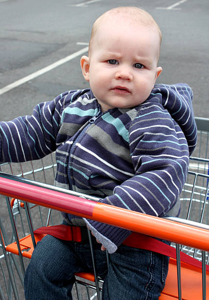 istock Baby boy in shopping trolley 182780820
