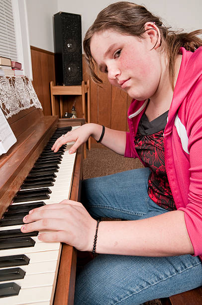 istock Teen Playing Piano Looking 182780964
