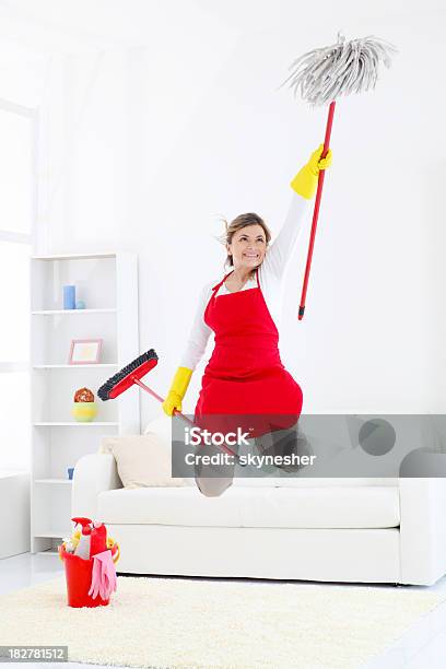 Happy Cleaning Lady Jumping With Broom And Mop Stock Photo - Download Image Now - One Woman Only, Sweeping, Women