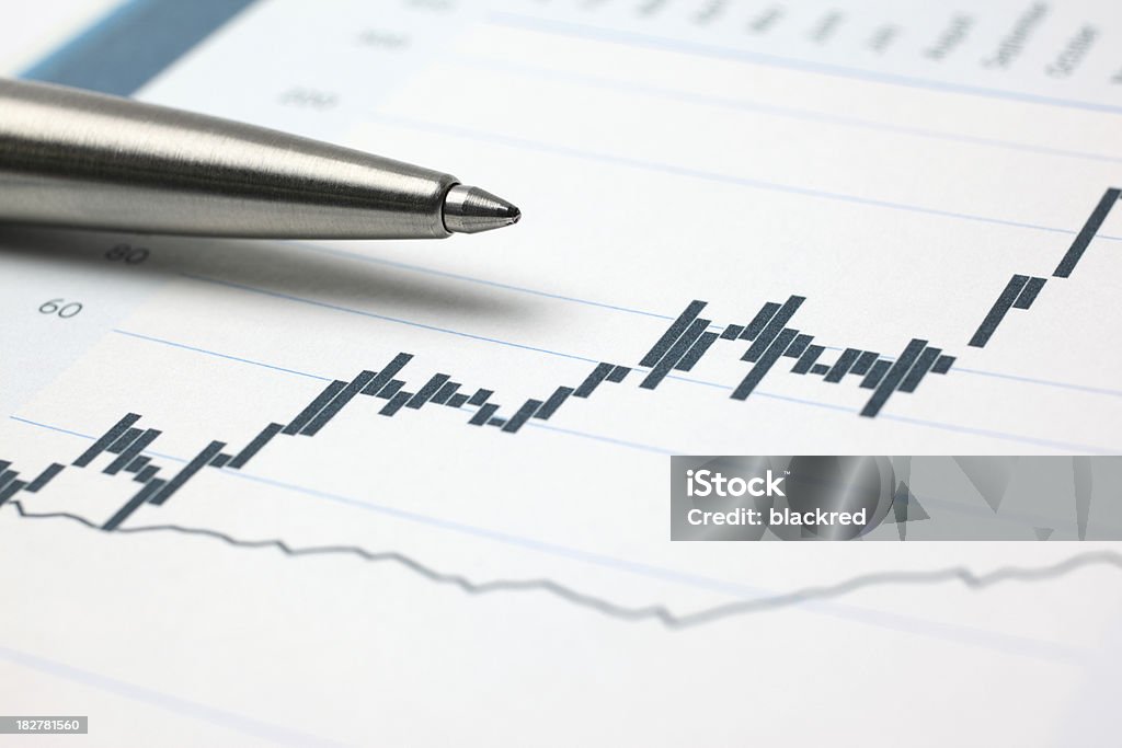 Investments Close-up of a pen on stock market chart. Analyzing Stock Photo