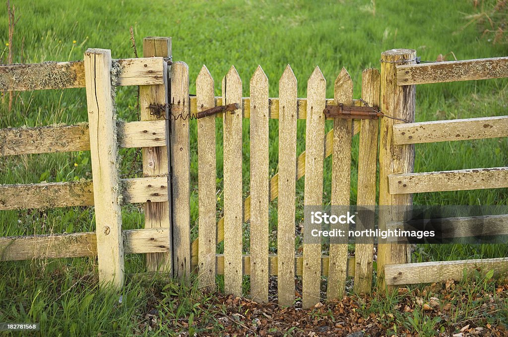 Wooden gate Close up of a wooden gate leading into a field. Fence Stock Photo