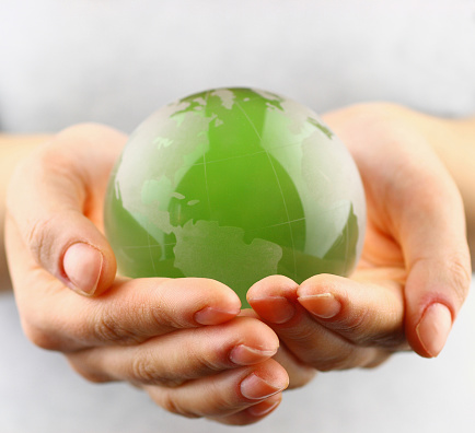 Green globe in  hands