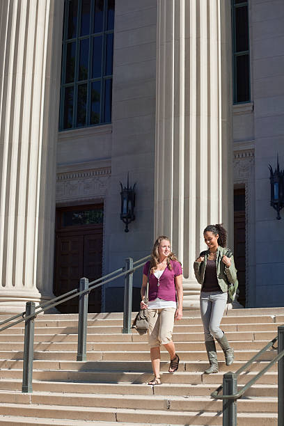 istock Two Students Walking Outside Academic Hall in University Campus 182782061