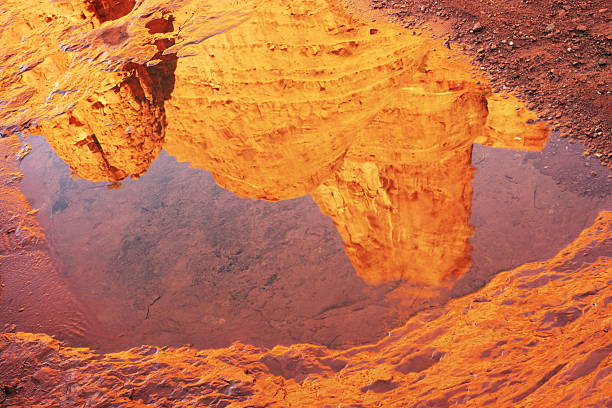 Sunrise illuminates red rock buttes with water reflection.  Sedona, Arizona, 2010.
