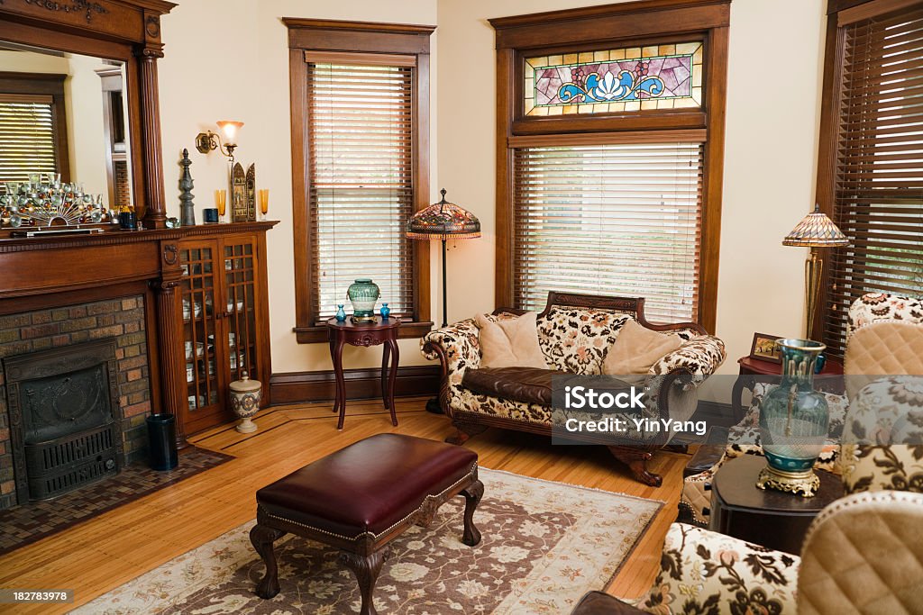 Victorian Style Living Room, Old-fashioned, Antique Domestic Residential Home Interior Victorian style living room, an old-fashioned, domestic residential home interior. The interior room of a renovated and restored house with antique furniture and accessories. Classic, traditional furnishings define the space, in a horizontal format with no people.  Old Stock Photo