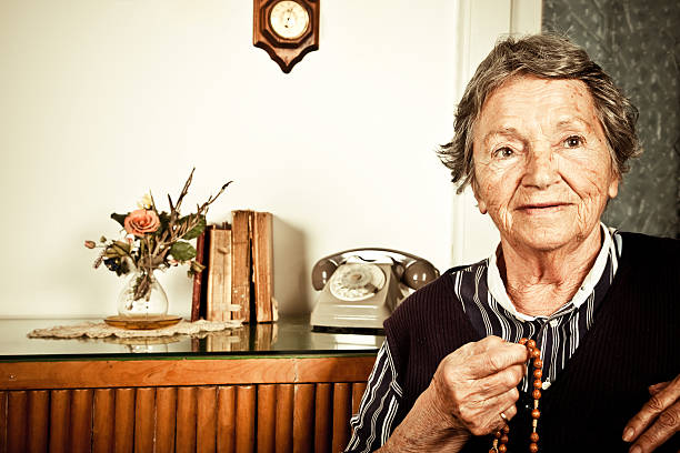 istock Elderly Woman Praying With Rosary 182784000
