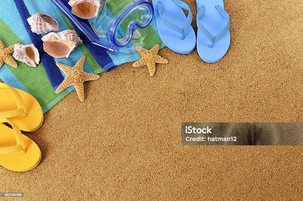 Beach background with copyspace "Beach background with seashells, beach towel, scuba mask, flip flops and starfish (studio shot - warm color and directional light are intentional).  To see my complete collection of beach backgrounds please" Above Stock Photo