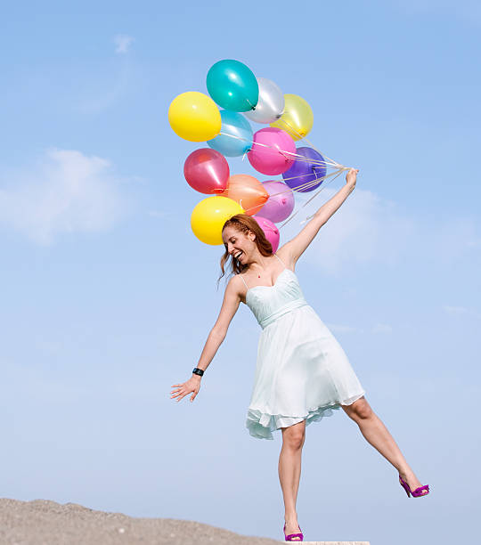 istock Young woman with balloons 182784325