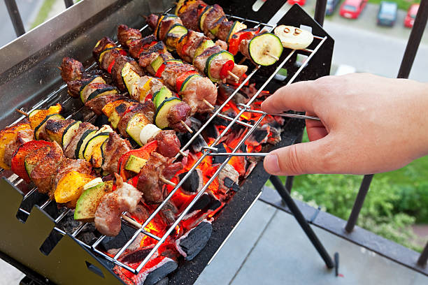 Grilling hot dogs and hamburgers outside in the summer